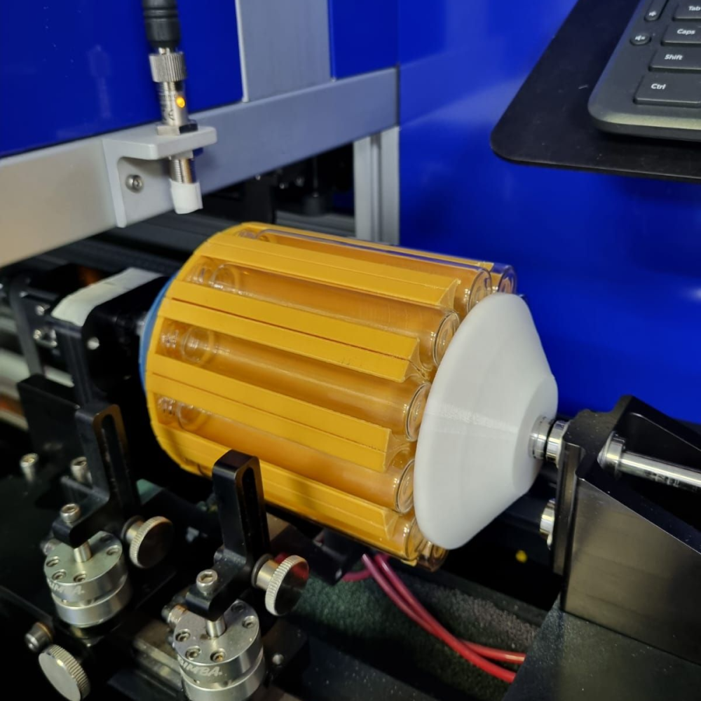 3D-printed jig with glass tubes, ready for the cylindrical printing run
